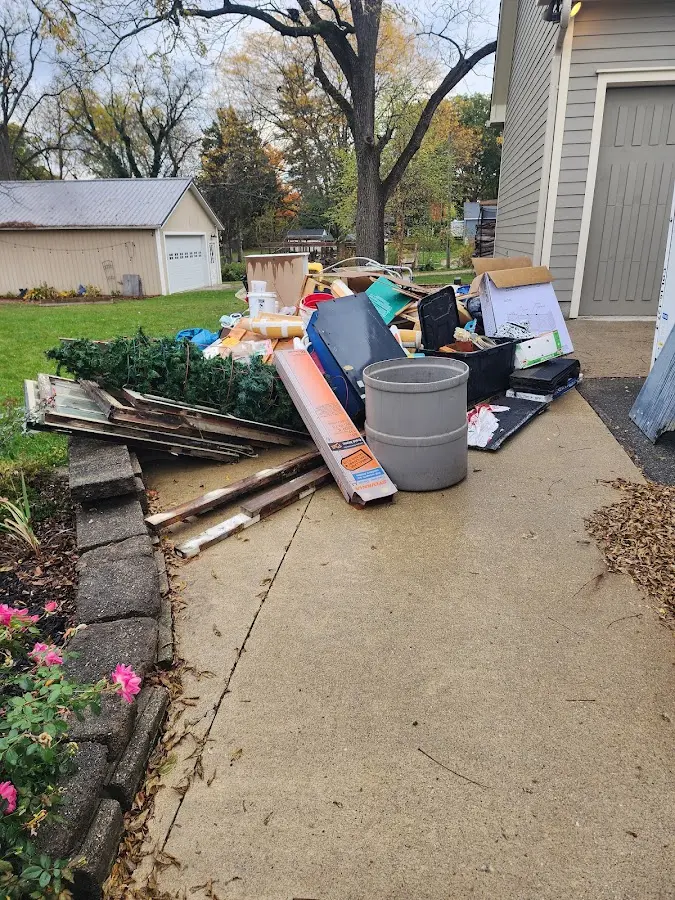 Dumpster being loaded with debris for Roofing Dumpster Rental in Clever